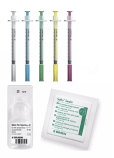 Syringes, a small vial and sealed swab packets on a white background