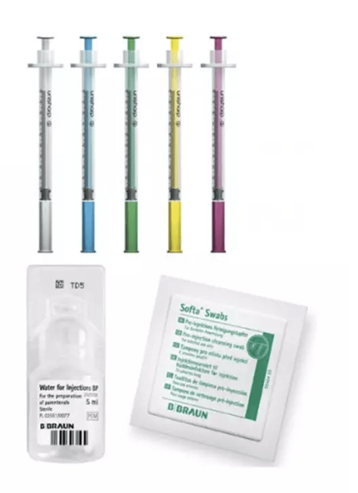 Syringes and sealed swab packets on a white background