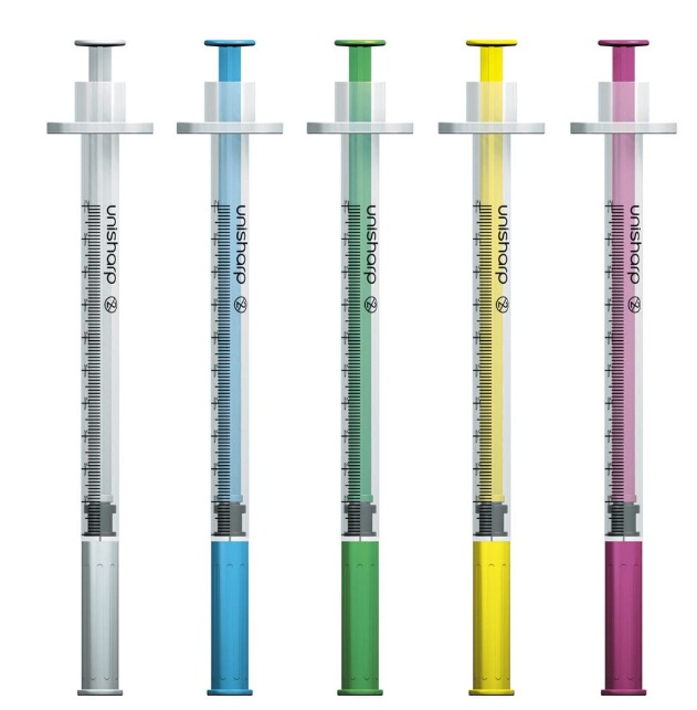 Five syringes with different coloured plungers on a white background